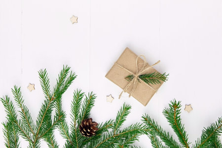 Christmas composition with fir tree branches and christmas decoration on white wooden background.の写真素材