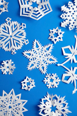 Composition with paper snowflakes on blue backgroundの写真素材