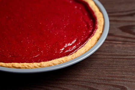 Homemade strawberry pie on dark wooden table background, top viewの写真素材