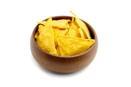 Nachos, corn chips in wooden bowl, snack isolated on white background. Fast food, suitable for...