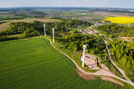 Wind turbines in green field, aerial view. Green energy, renewable energy