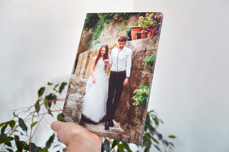 Canvas print stretched on stretcher bar with gallery wrap, hand holds wedding photography, photo...