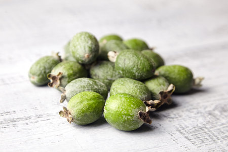 Feijoa fruits or pineapple guava on gray wooden table