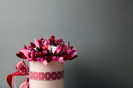 Dried flower bouquet with grasses in pink round hat boxの写真素材