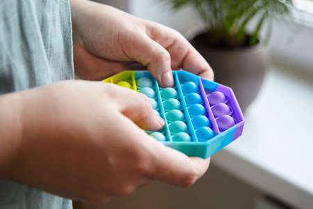 Push pop bubble sensory fidget toy octagon shape in handsの写真素材