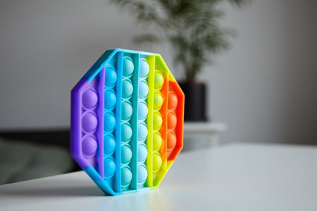 Push pop bubble sensory fidget toy octagon shape on tableの写真素材