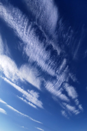 Blue sky with white spindrift clouds