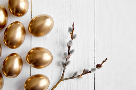 Easter eggs with pussy willow branches on white wooden table happy holiday background top view