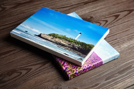 Canvas photo prints stretched onto frame with bleed and white edge on wooden tableの写真素材
