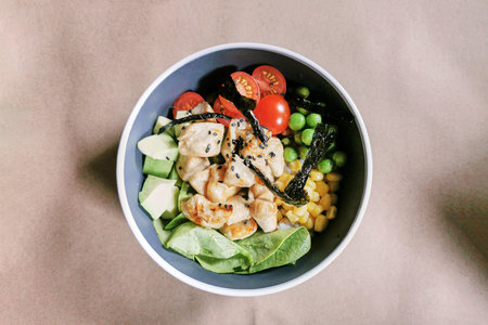 Poke bowl with chicken fillet and avocado, healthy food, top view
