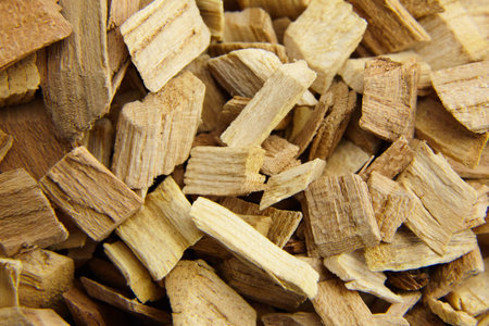 Wood chips for smocking texture background. Natural apricot wood smoking chunks