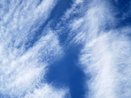 Blue sky with white spindrift cloudsの写真素材