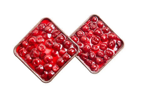 Mini viennese cherry pies in paper tray isolated on white background. Biscuit cake with cherry and jelly, top viewの写真素材