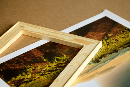 Photo canvas print and wooden stretcher bar on fiberboard table. Landscape photography printed on canvasの写真素材