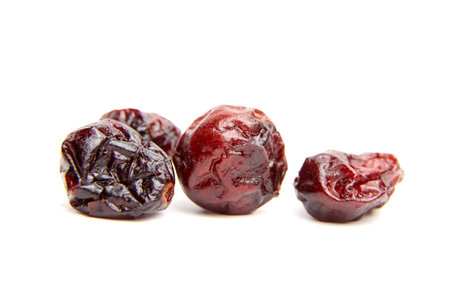 Dried cranberries isolated on a white background. Group of sweetened red cranberries closeupの写真素材