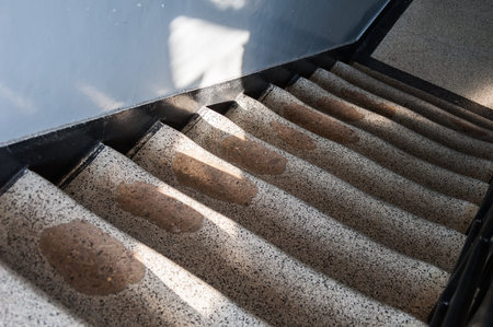 Rutted granite staircase worn out to the point of revealing the concrete underneathのeditorial素材