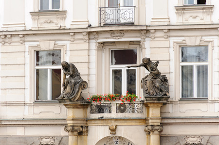 PRAGUE, CZECH REPUBLIC - JULY 8, 2009: Two sandstone sculptures decorate the entrance of Schier's house at the old town squareのeditorial素材