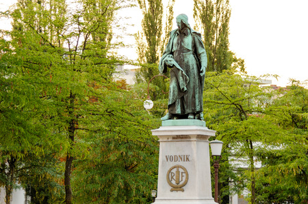 LJUBLJANA, SLOVENIA - JULY 9, 2009: Statue of Valentin Vodnik on a stone pedestal, a Slovene priest, journalist, and poet, at Vodnik square near the Central Market. RF stands for Republique Francaiseのeditorial素材