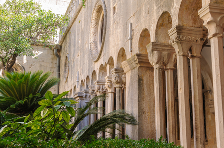 DUBROVNIK, CROATIA - SEPTEMBER 1, 2009: Double column colonnades with individualized capitals along the cloister of the Franciscan monasteryのeditorial素材
