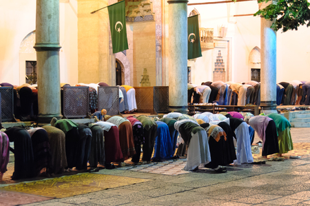 SARAJEVO, BOSNIA AND HERZEGOVINA - SEPTEMBER 3, 2009: Segregated muslims bowing in Isha prayer at Gazi Husrev-beg mosqueのeditorial素材