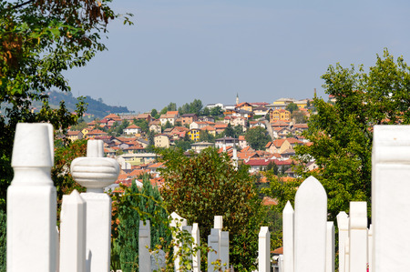 SARAJEVO, BOSNIA AND HERZEGOVINA - SEPTEMBER 4, 2009: Alifakovac cemetery tombstones and view of the old Bistrik townのeditorial素材
