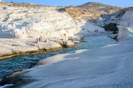 MELOS, GREECE - SEPTEMBER 4, 2012: Sarakiniko cove, beach and gorge with people sunbathing and swimming.のeditorial素材