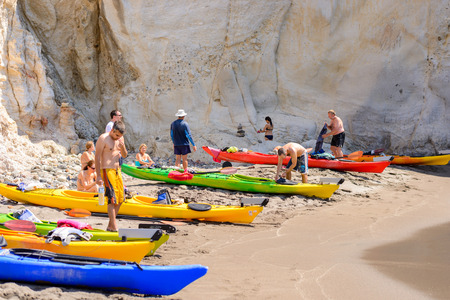 MELOS, GREECE - SEPTEMBER 4, 2012: People with kayaks pulled out on the shore of Gerontas beach off the south coast of Melos island.のeditorial素材