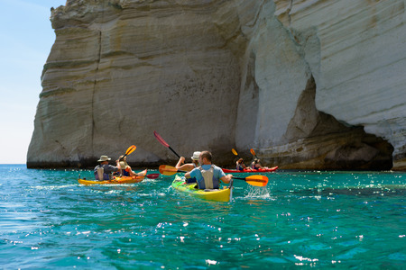 MELOS, GREECE - SEPTEMBER 4, 2012: People with kayaks exploring the rock formations and caves at Kleftiko at the southwest coastline of Melos island.のeditorial素材