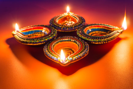 Indian festival Diwali, Diya oil lamps lit on colorful rangoli. Hindu traditional. Happy Deepavali....