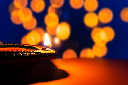 Indian festival Diwali, Diya oil lamps lit on colorful rangoli. Hindu traditional. Happy Deepavali. Copy space for text.の写真素材