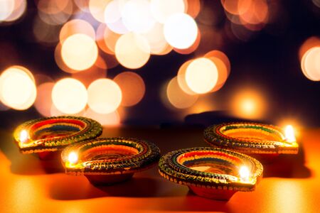 Indian festival Diwali, Diya oil lamps lit on colorful rangoli. Hindu traditional. Happy Deepavali. Copy space for text.の写真素材