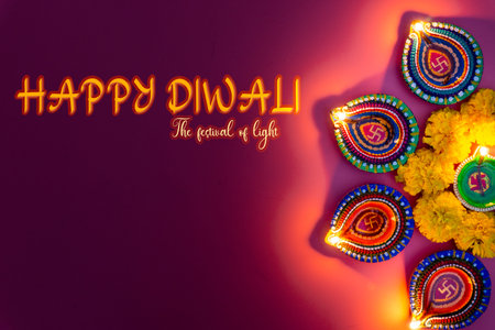 Indian festival Diwali, Diya oil lamps lit on colorful rangoli. Hindu traditional. Happy Deepavali. Copy space for text.の写真素材