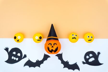 Top view of Halloween decoration, jack o lantern, ghost, bat and spider on yellow background with copy space for text. halloween concept.の写真素材