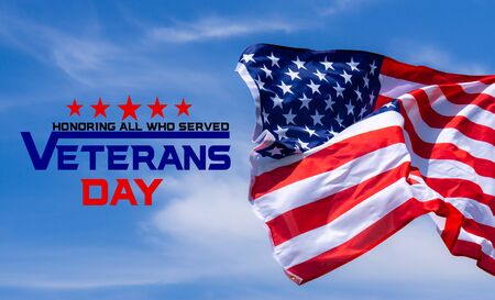 Happy Veterans Day with American flags on blue sky background.の写真素材