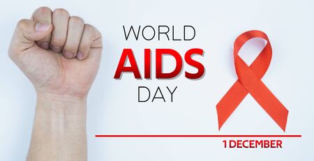 Aids awareness, male hands stranglehold and red AIDS awareness ribbon on white background. World Aids Day, Healthcare and medical concept.の写真素材