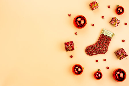 Christmas holidays composition, top view of red Christmas decorations on yellow background with copy...