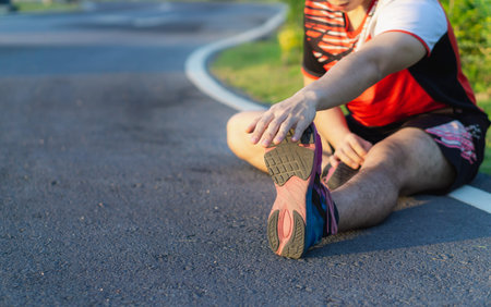 athlete man stretching his legs or calf muscle before exercising and running. Sport and exercise...