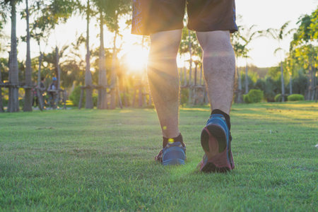 Closeup shoe. Male legs jogging and walking at the park. Sport and exercise concept