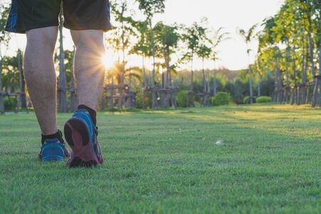Closeup shoe. Male legs jogging and walking at the park. Sport and exercise conceptの写真素材