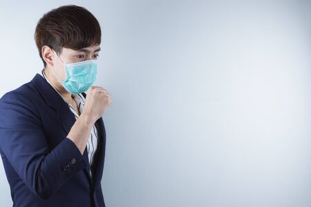 The business man coughing flu from coronavirus and pm 2.5. Coronavirus and Air pollution pm 2.5 concept.の写真素材