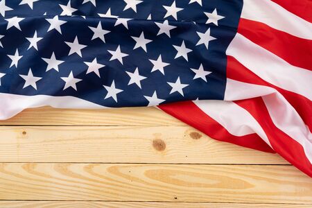 US American flag on wooden background. For USA Memorial day, Presidents day, Veterans day, Labor day, Independence or 4th of July celebration. Top view, copy space for text.の写真素材