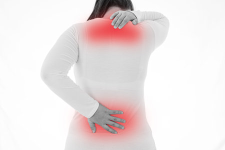 Black and white shot of woman feeling exhausted and suffering from neck and back pain and injury on...