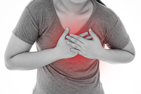 Black and white shot of woman feeling exhausted and suffering from heart pain and injury on isolated...
