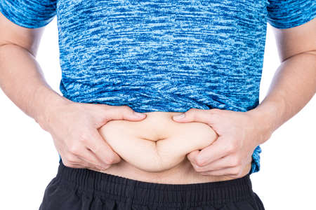Fat man holding excessive fat belly, overweight fatty belly isolated on over white background. Diet lifestyle, weight loss, stomach muscle, healthy concept.の写真素材