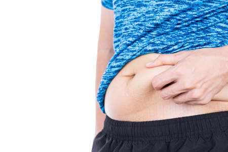 Fat man holding excessive fat belly, overweight fatty belly isolated on over white background. Diet lifestyle, weight loss, stomach muscle, healthy concept.の写真素材