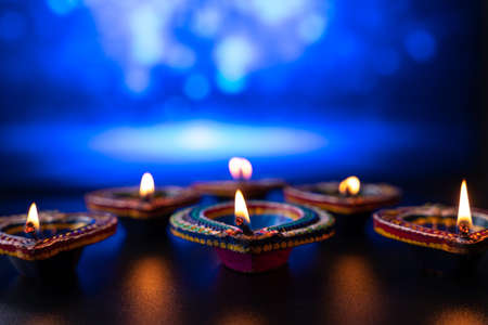 Indian festival Diwali, Diya oil lamps lit on colorful rangoli. Hindu traditional. Happy Deepavali. Copy space for text.の写真素材