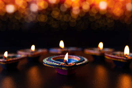 Indian festival Diwali, Diya oil lamps lit on colorful rangoli. Hindu traditional. Happy Deepavali. Copy space for text.の写真素材