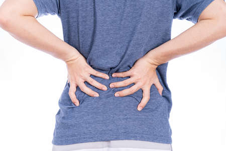 Man suffering from waist and back pain isolated white background. Health care and medical concept.の写真素材