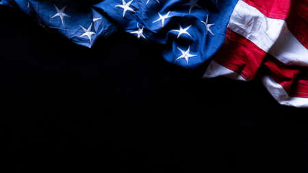 US American flag against black background. For Memorial, Presidents, Veterans, Labor, Independence or 4th of July celebration day. Top view, copy space for text.の写真素材
