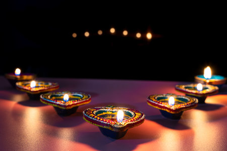 Indian festival Diwali, Diya oil lamps lit on colorful rangoli. Hindu traditional. Happy Deepavali....